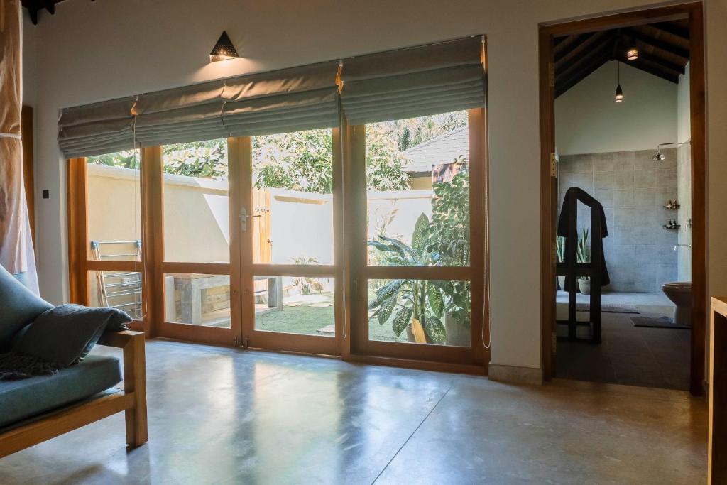 a living room with a large sliding glass door at The Spice Trail in Arugam Bay