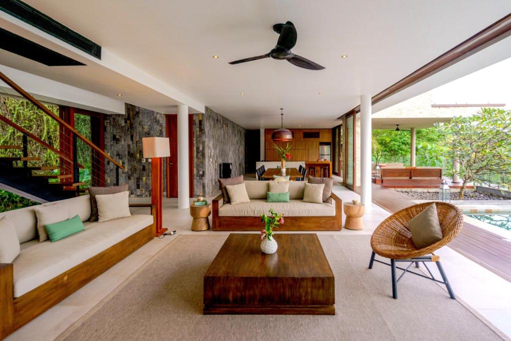 a living room with a couch and a table at Selong Selo Resort and Residences in Selong Belanak
