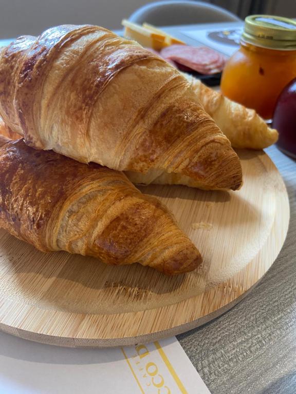 two croissants on a cutting board on a table at B&B Berninapass in Poschiavo