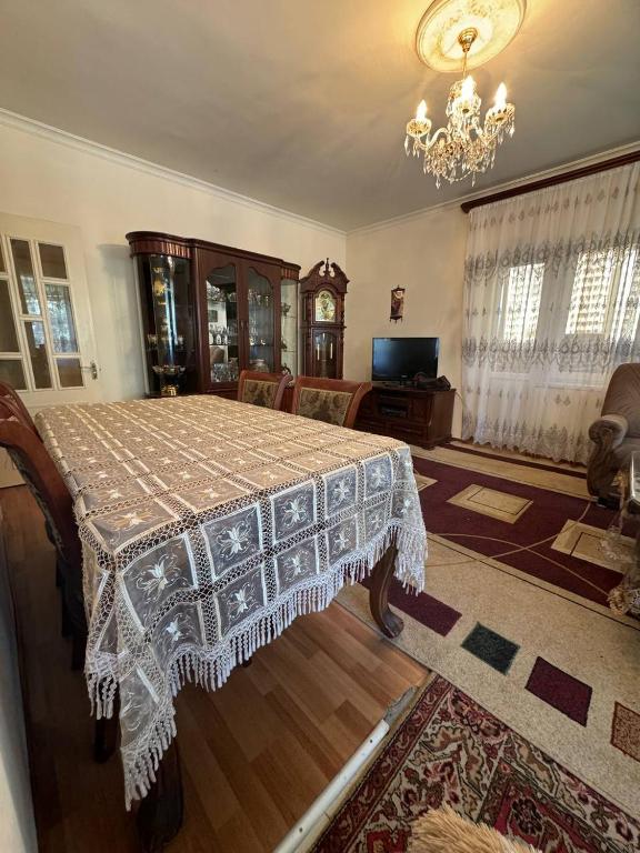 a dining room with a table and a chandelier at Sevan - The Sun in Sevan