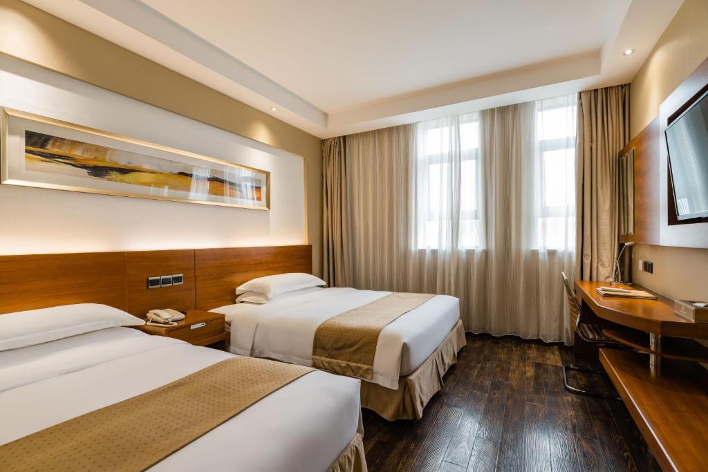 Postel nebo postele na pokoji v ubytování Maixinge Boutique Hotel Chuansha Branch