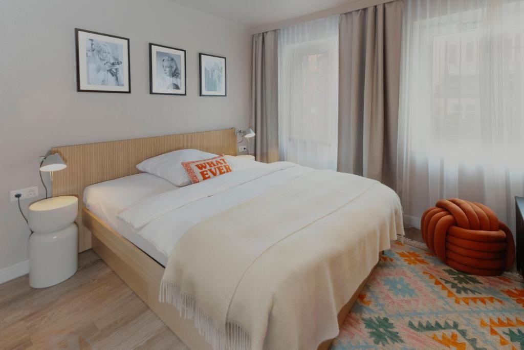 a bedroom with a large bed and a window at Hotel Lux in Munich