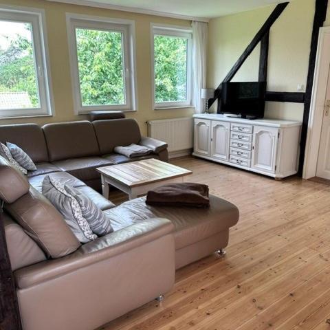 a living room with a couch and a flat screen tv at Landferienwohnung 1 Danneborth in Danneborth