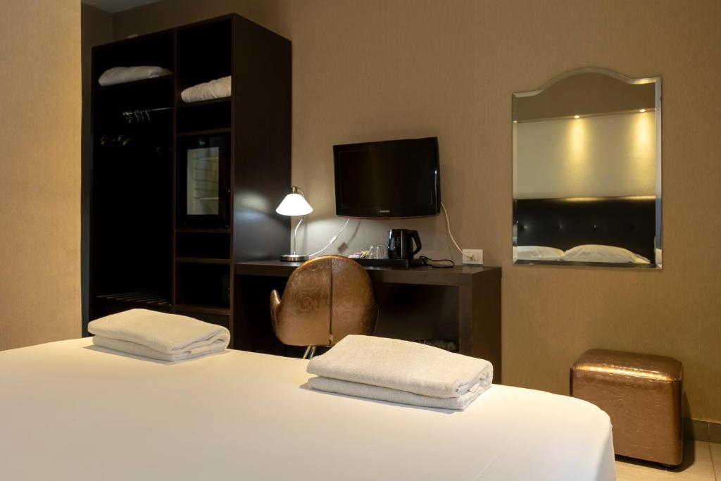 Postel nebo postele na pokoji v ubytování Napolit'amo Hotel Medina