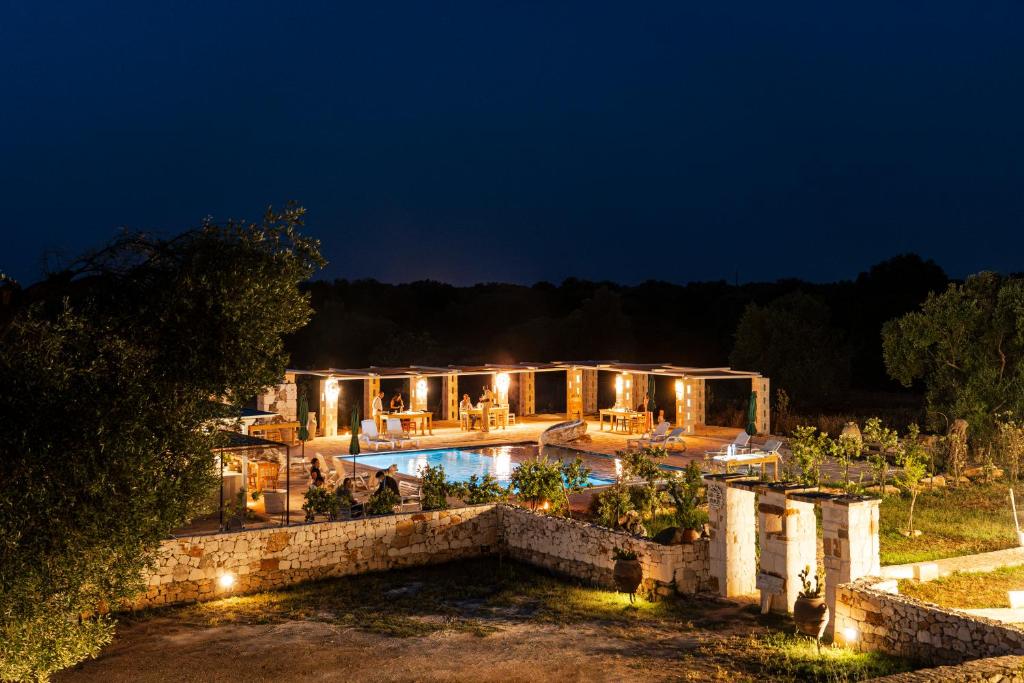 an estate with a swimming pool at night at Masseria della Piana in Villanova di Ostuni