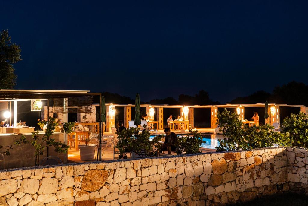 a resort with a swimming pool at night at Masseria della Piana in Villanova di Ostuni