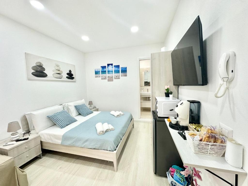 a bedroom with a bed and a tv in it at Ale & Andry House in Cefalù