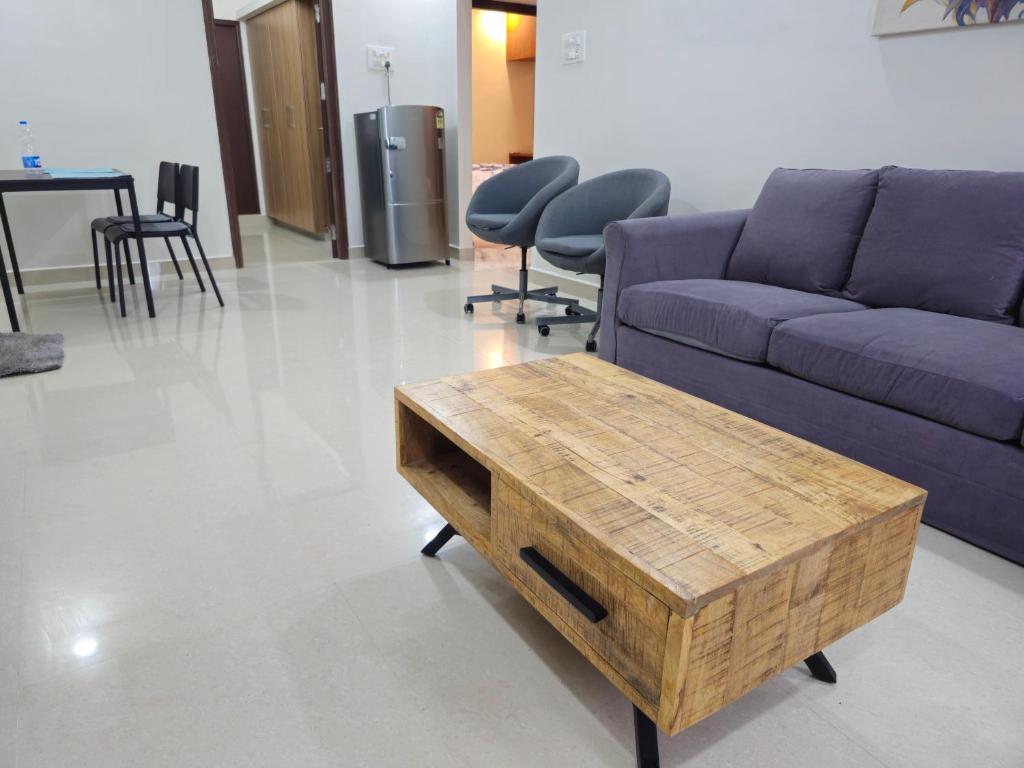 a living room with a couch and a coffee table at VEDHA Homestay in Tirupati