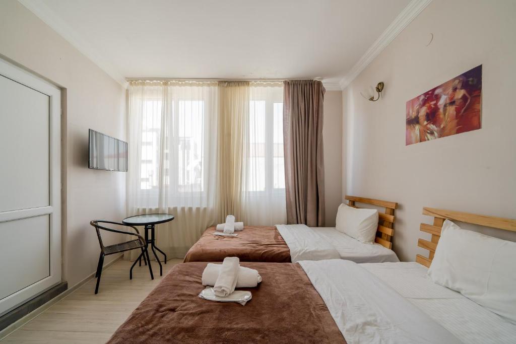 Postel nebo postele na pokoji v ubytování Hotel Tato & CoWorking space