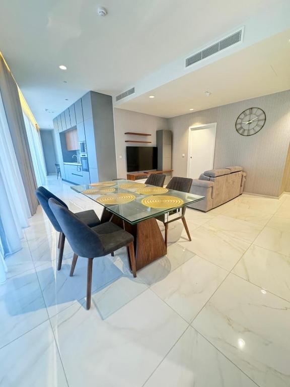 a dining room with a glass table and chairs at Mercury Tower Apt 508 in St. Julianʼs