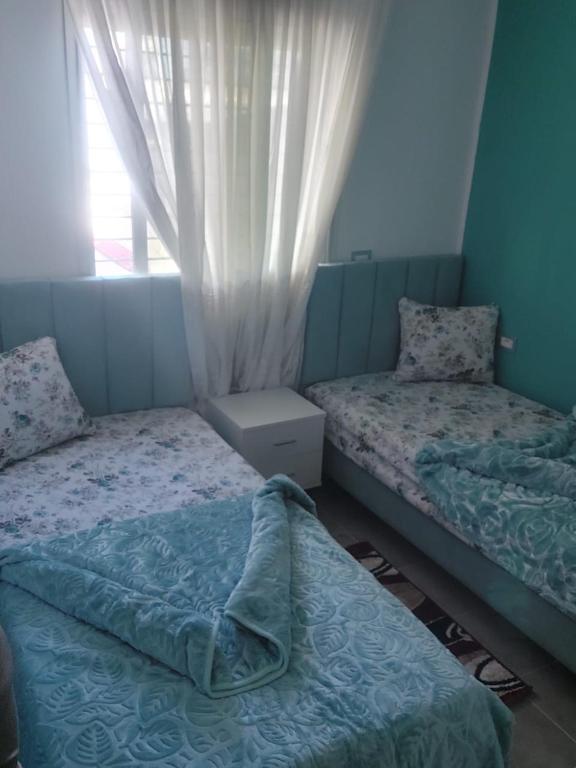 a bedroom with two beds and a window at Dar Z LeKbira in Tunis