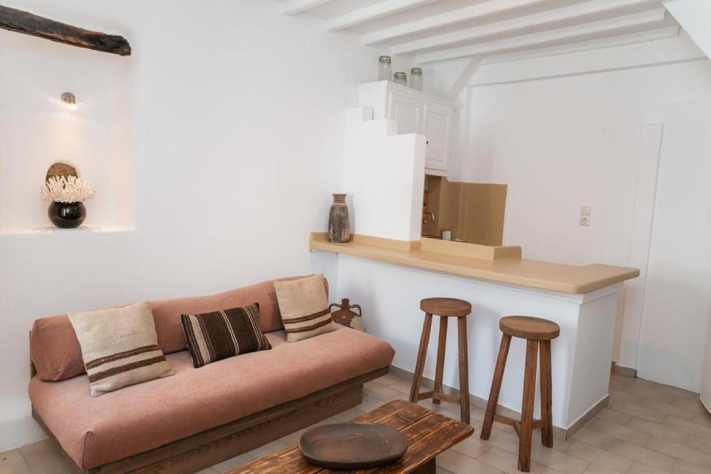 a living room with a couch and a table at Manto Sunset Loft in Mýkonos City