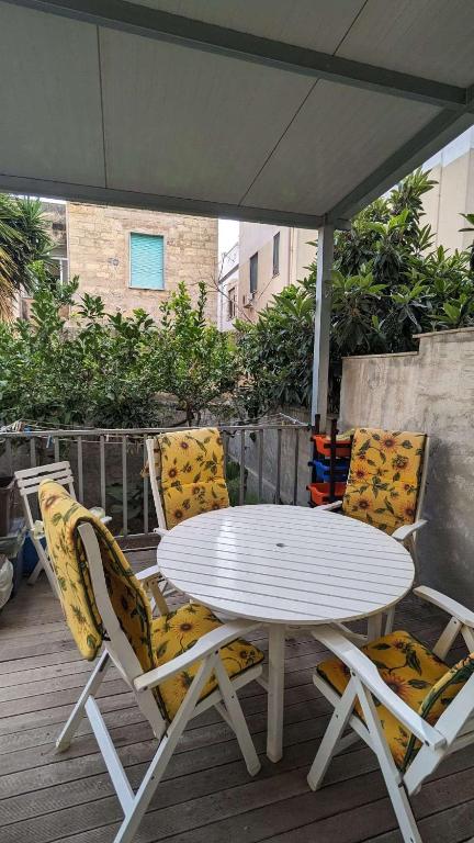 a white table and two chairs on a deck at Vititta Appartamenti in Trapani