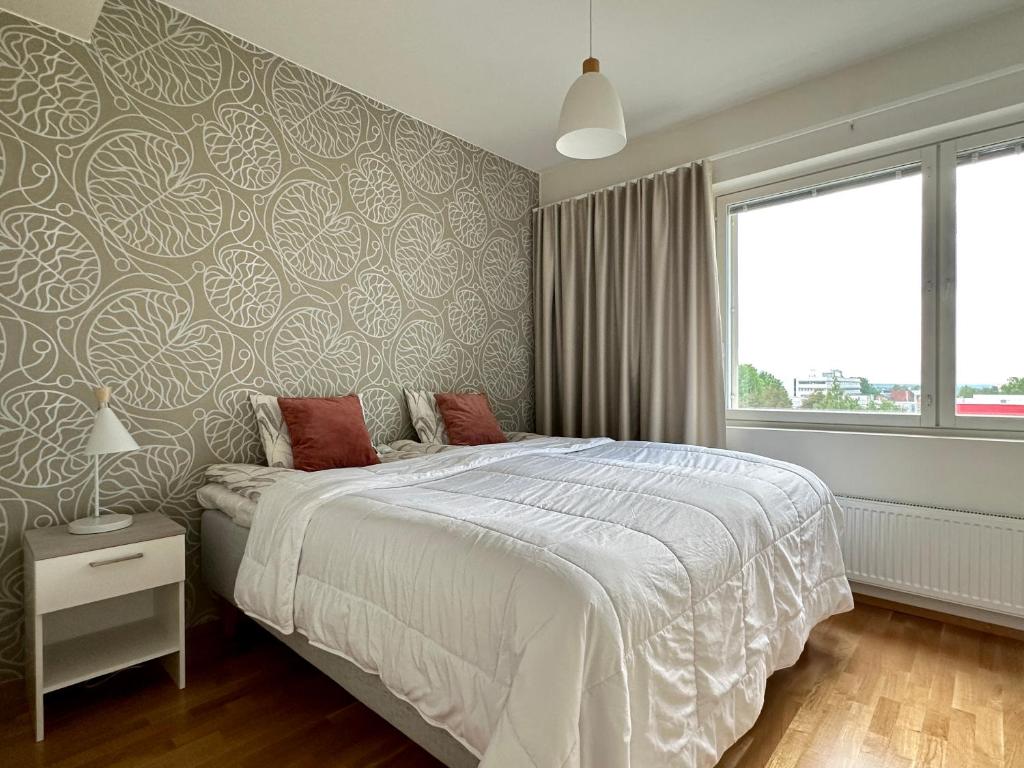 Postel nebo postele na pokoji v ubytování Aurora Sky Apartment