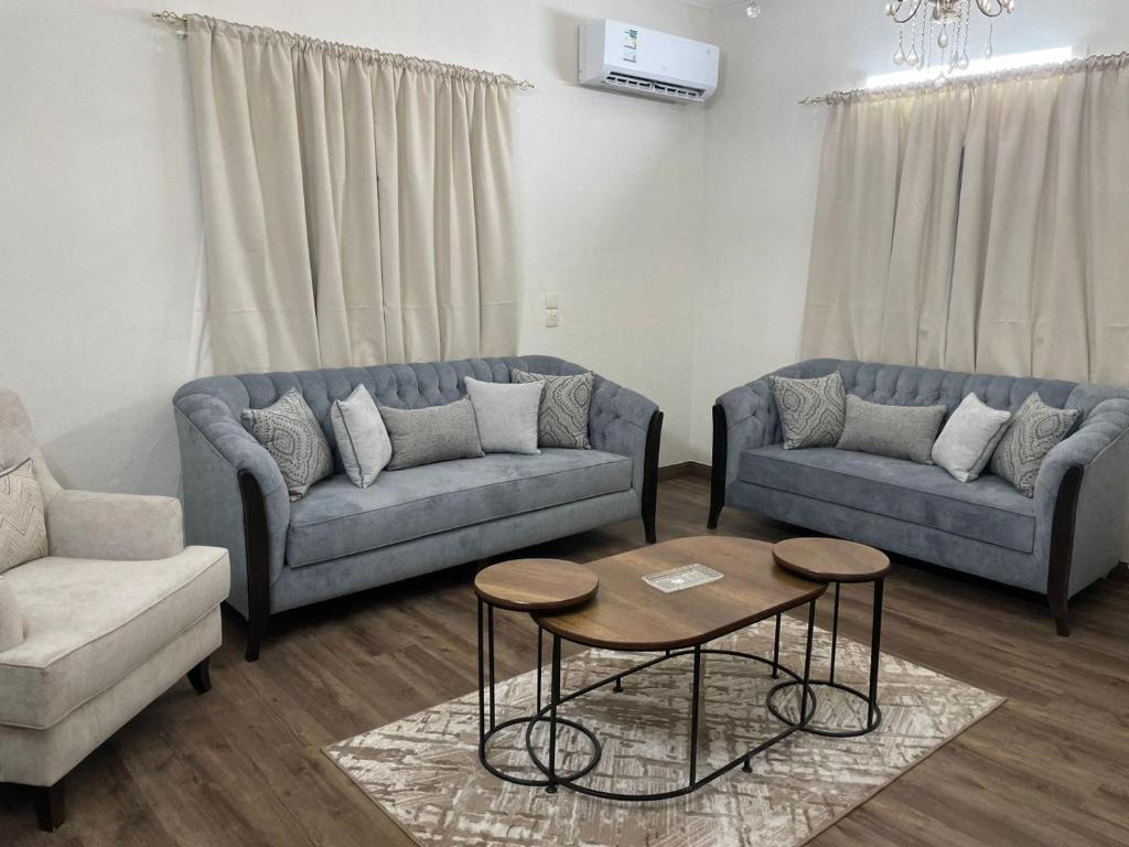 a living room with two couches and a table at شقق مفروشه للايجار اليومي بالطائف in Al Ḩawīyah