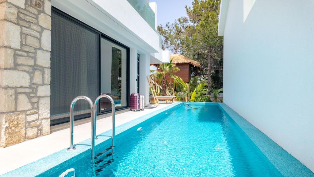a swimming pool in the backyard of a house at D PALM Premium Living - Kalathas, Chania in Chania Town