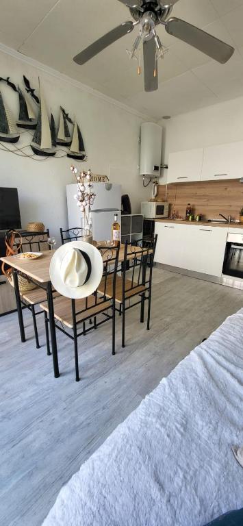 une cuisine et une salle à manger avec une table et des chaises dans l'établissement La Mouette 2 pièces rénovées et climatisé 300 plage et commerces, au Grau-du-Roi