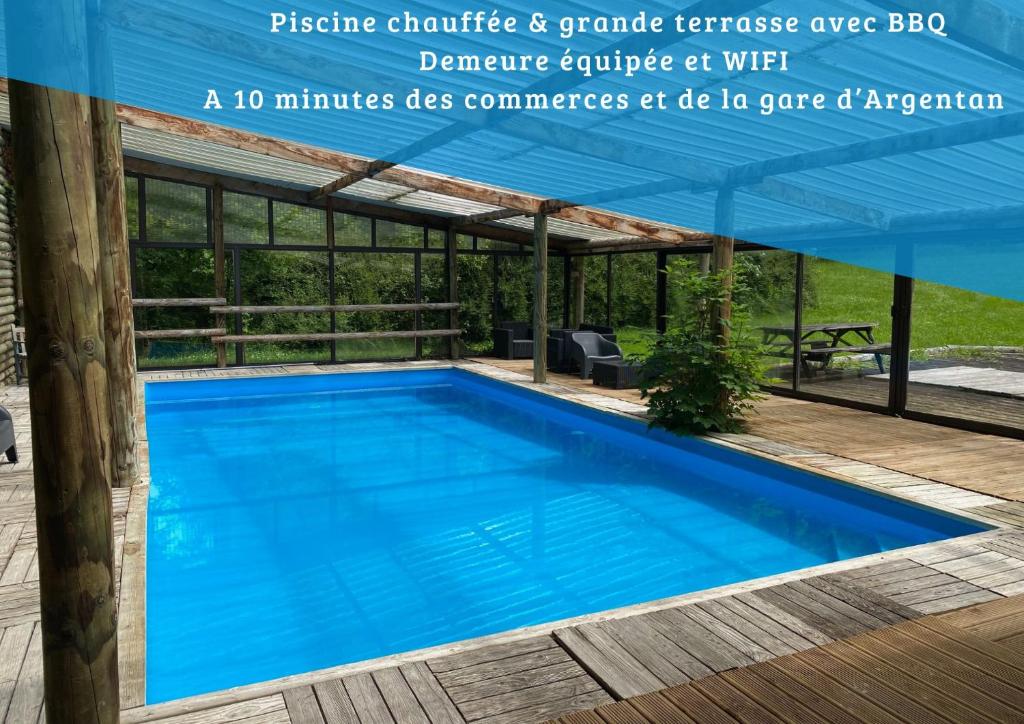a pool with a pergola and a blue swimming pool at La Demeure du Domaine de Tertu, 12p, PISCINE in Villedieu-lès-Bailleul