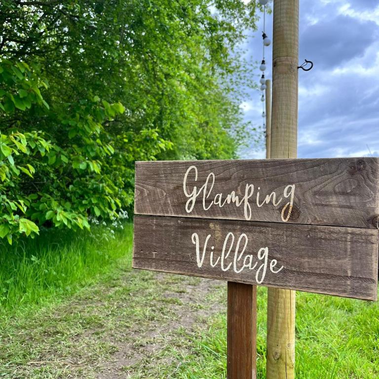 a wooden sign that reads handwriting wildlife at Birch Bell Tent in Droitwich