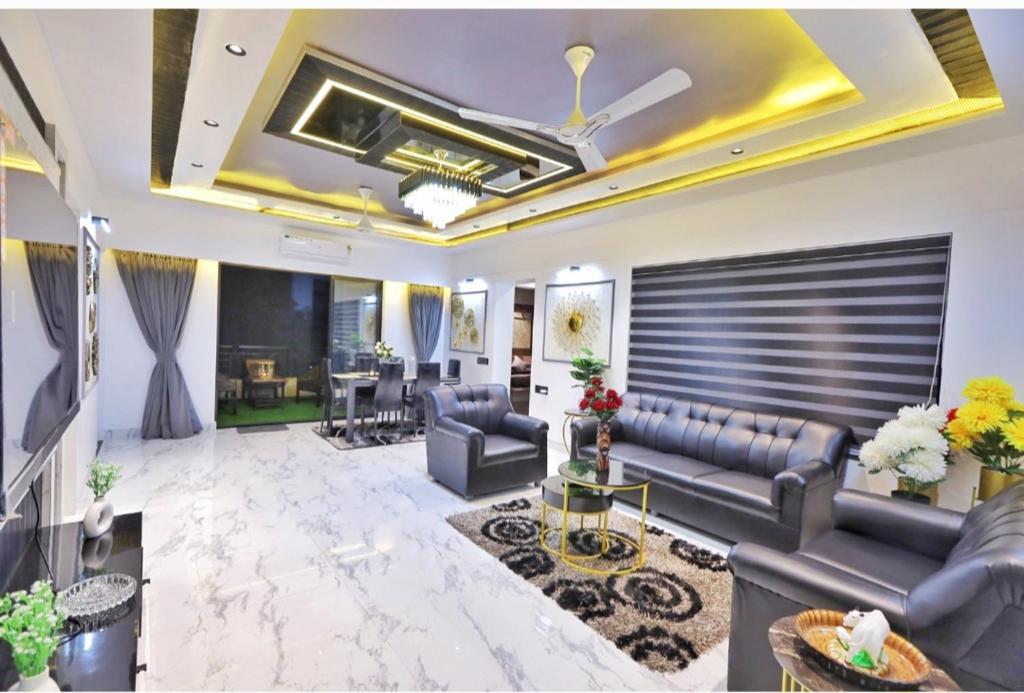 a large living room with couches and a table at Classic Premium luxurious 3bhk fully furnished apartment in koregaon park in Pune