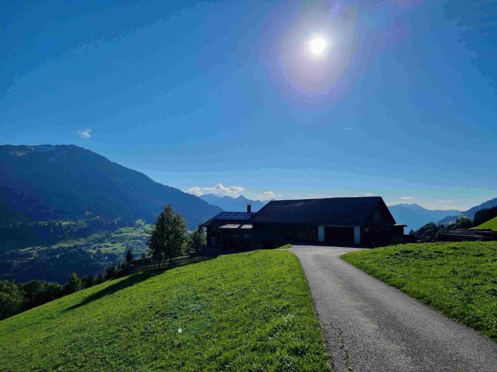 a house on a hill next to a road at Haus Mura in Blons