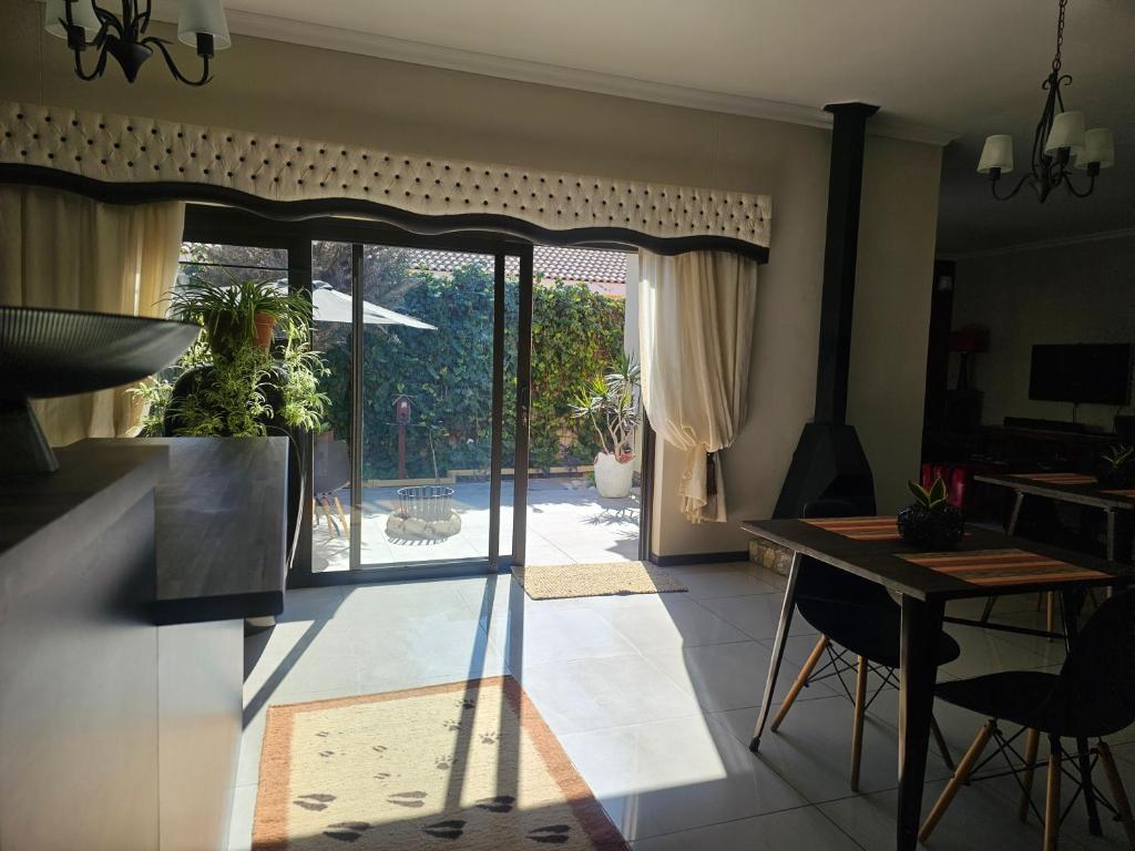a kitchen with a door open to a patio at Cora's Boutique Bed & Breakfast in Swakopmund