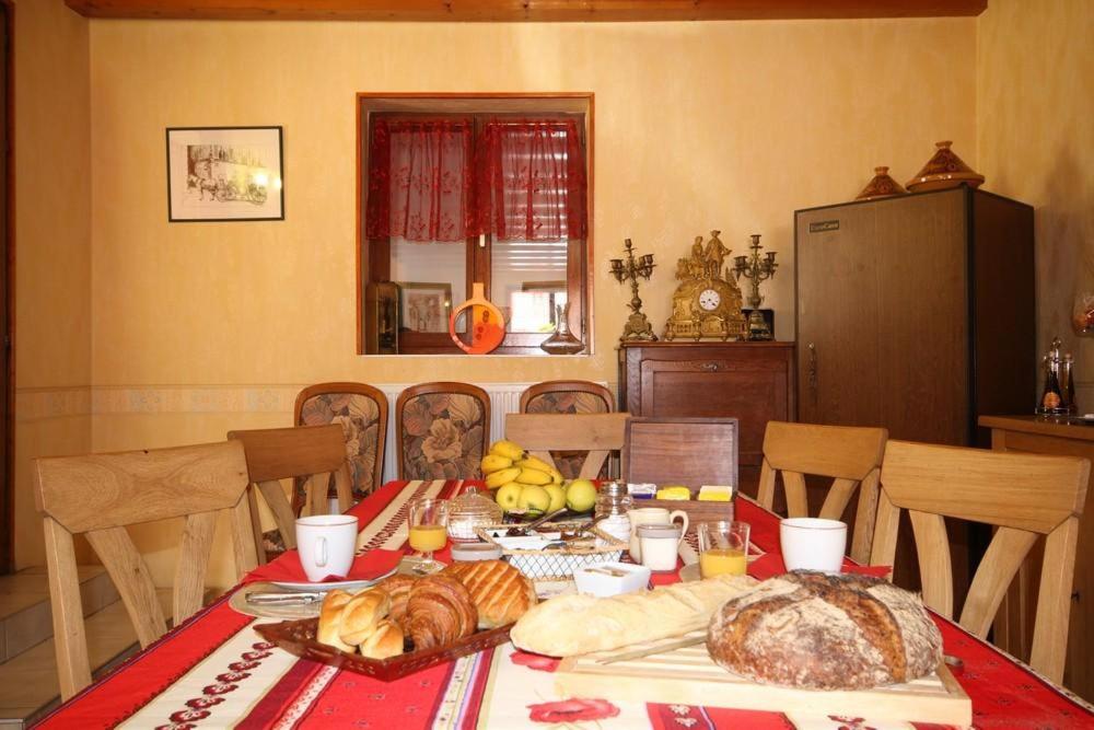 a dining room table with a turkey and bread on it at Chez Marie-Anne in Sacquenay