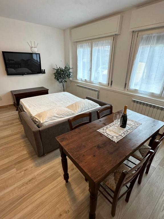 un soggiorno con letto, tavolo e sidro. di Borgo nel Vigneto a Erbusco