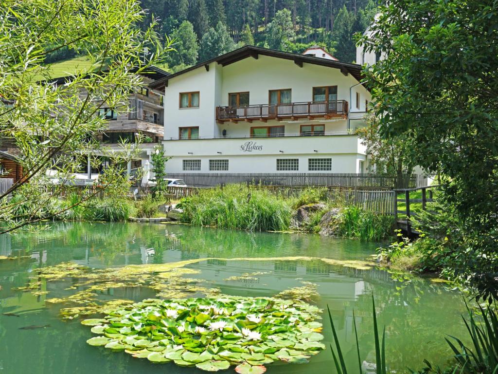 a pond with lily pads in front of a building at Apartment Hirsch by Interhome in See