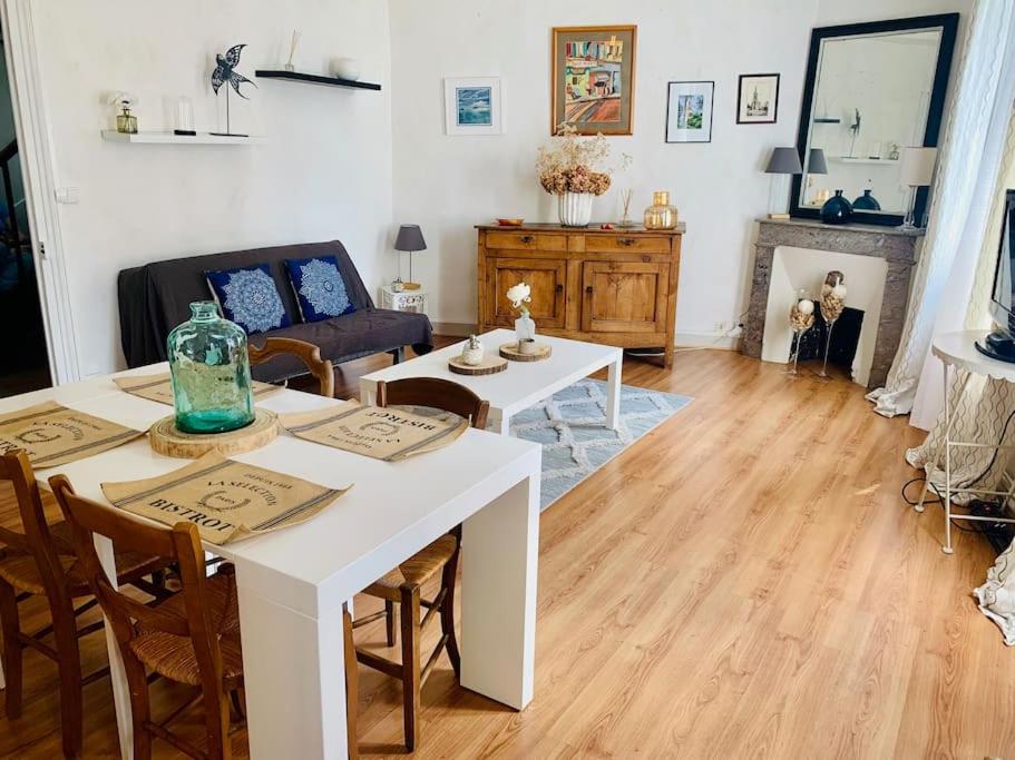 - un salon avec une table et des chaises blanches dans l'établissement Maison de ville au Cœur d'Angoulême- 2 chambres-Wifi- Cosy - Idéal de 1 à 6 Personnes - conciergerie J&N, à Angoulême