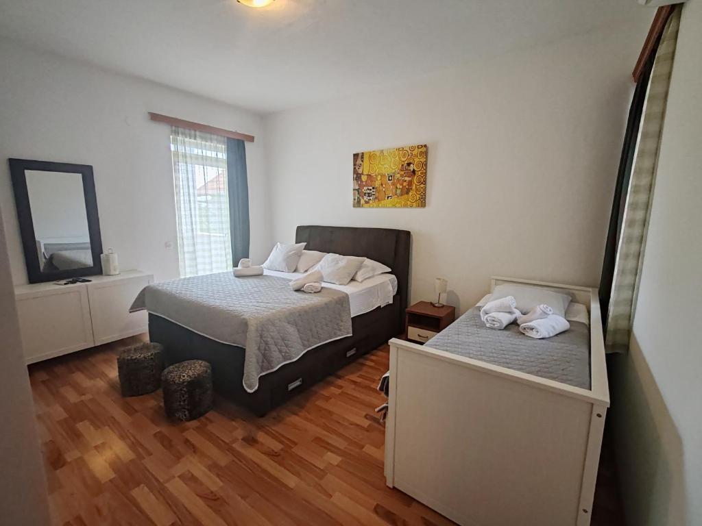 Postel nebo postele na pokoji v ubytování Apartments and pansion M&R