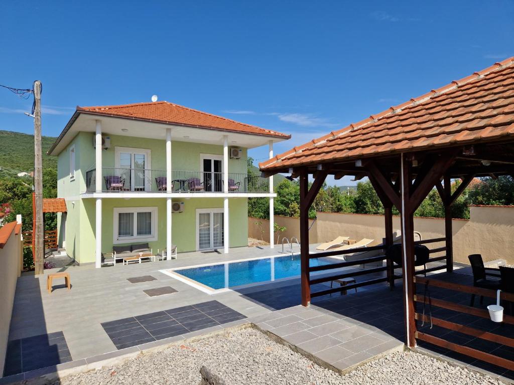 a villa with a swimming pool and a house at Villa Aberdeen in Tivat