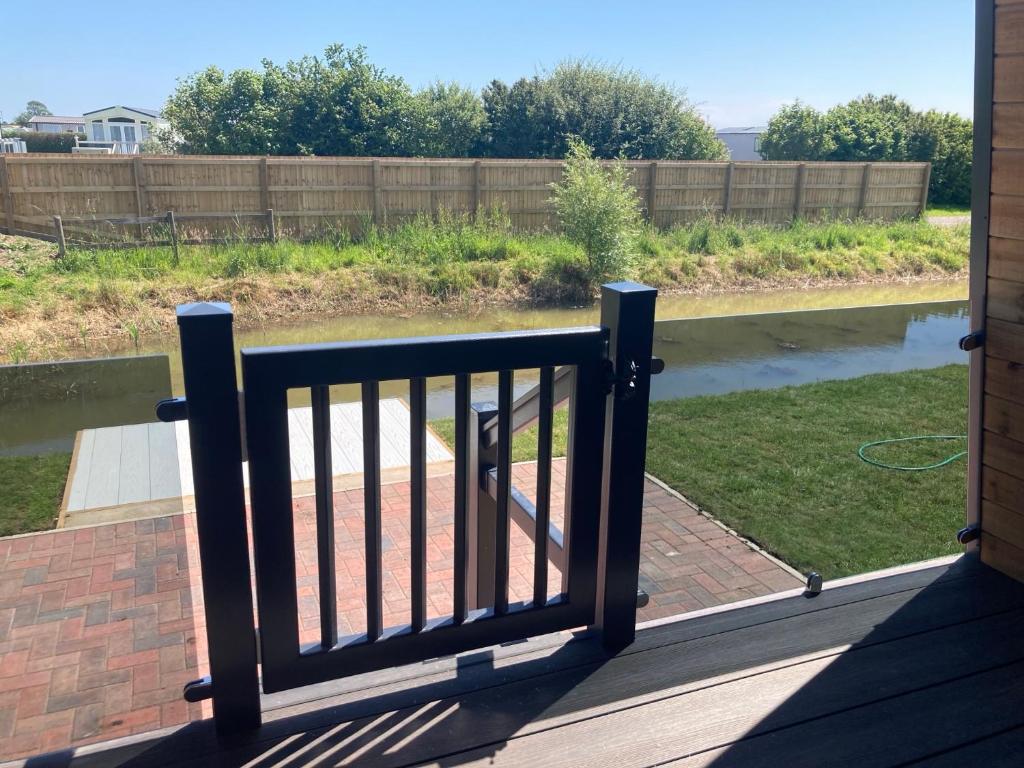 a balcony with a railing with a view of a river at Chapel Fields Holiday Park in Chapel Saint Leonards