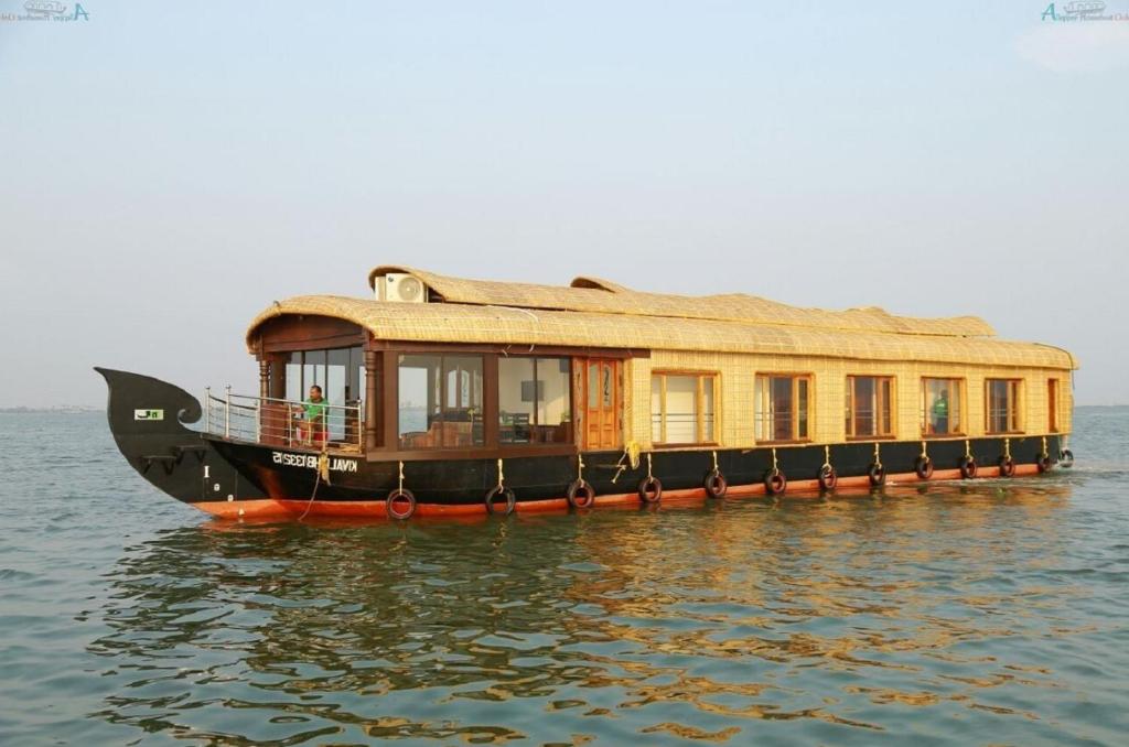 a house boat sitting in the water at Northstar 5 Bedroom Ac Private Houseboat With All Meals in Alleppey