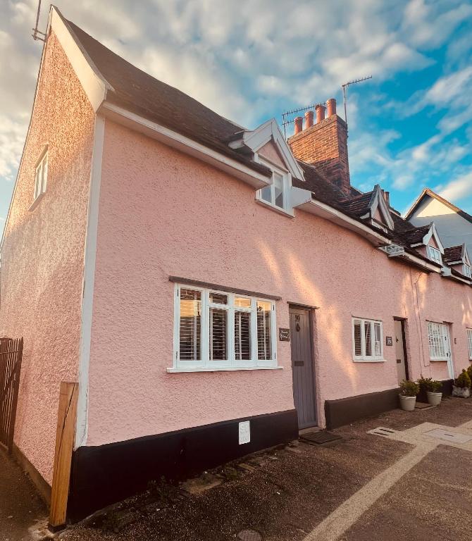 a pink house with a black roof at Lavender Cottage, Clare in Clare