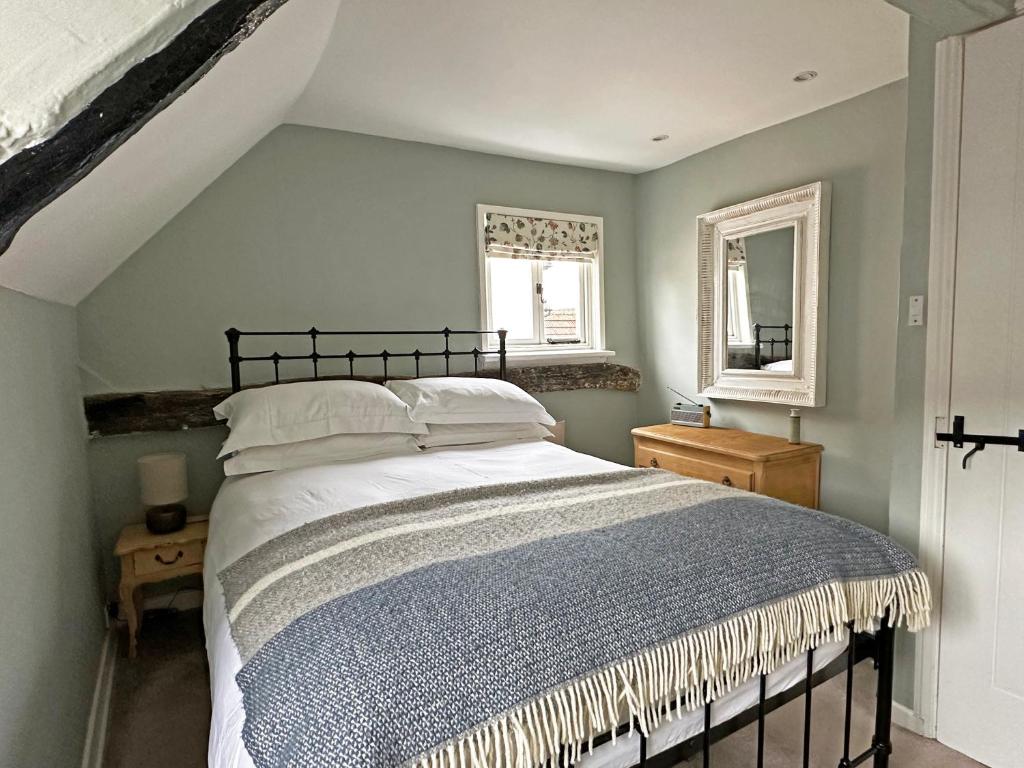 a bedroom with a bed and two windows at Lavender Cottage, Clare in Clare