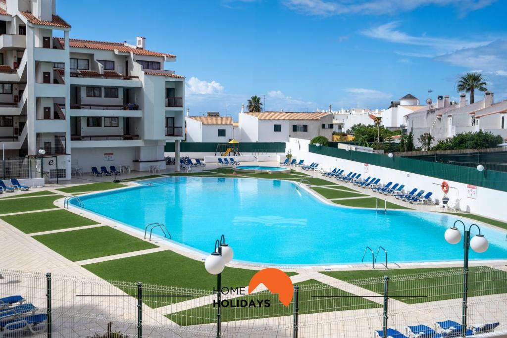 a large swimming pool in front of a building at #212 Vila Magna 106B by Home Holidays in Vale de Pedras