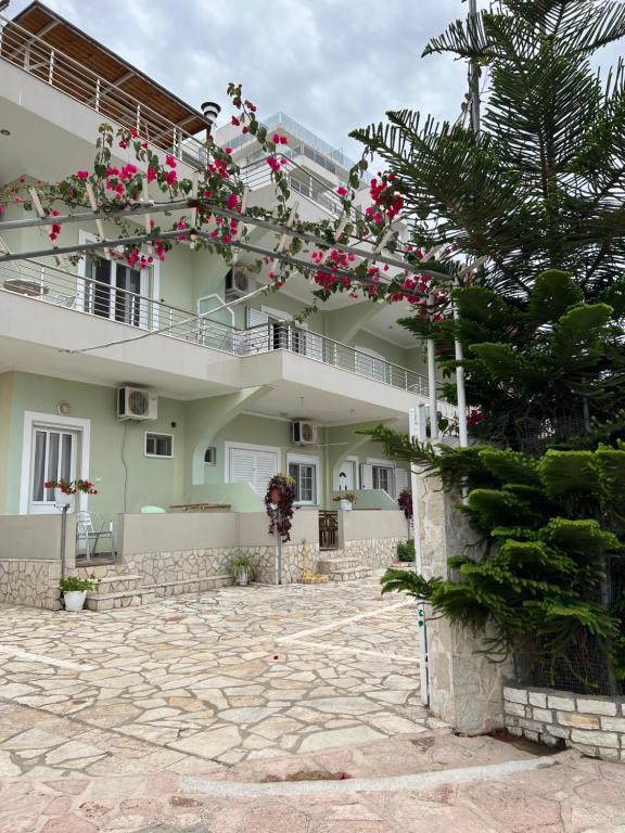 a building with pink flowers on it at Villa AlMar in Sarandë