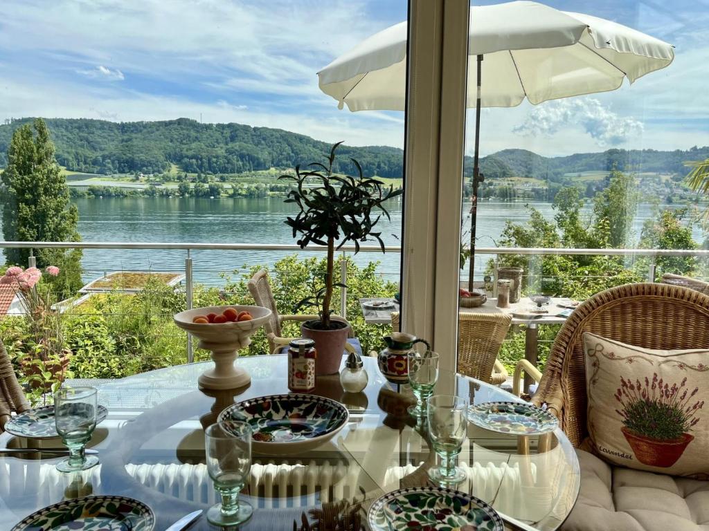 a table with a view of the water at Holiday Home Seepanorama by Interhome in Wangen
