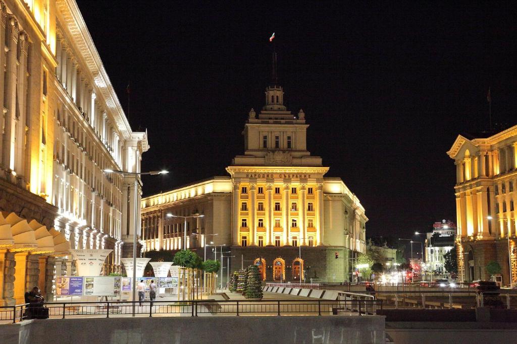 a large building with a tower on top of it at night at La Casa di Sofia in Sofia
