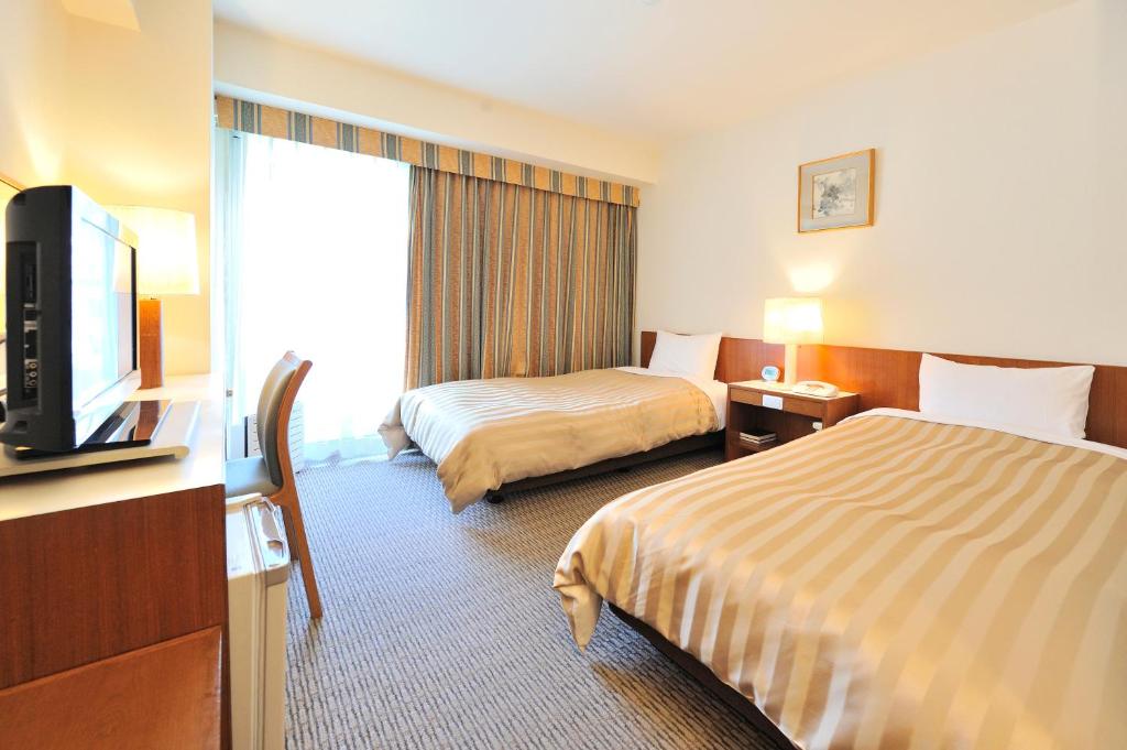 Postel nebo postele na pokoji v ubytování Hotel Gimmond Kyoto