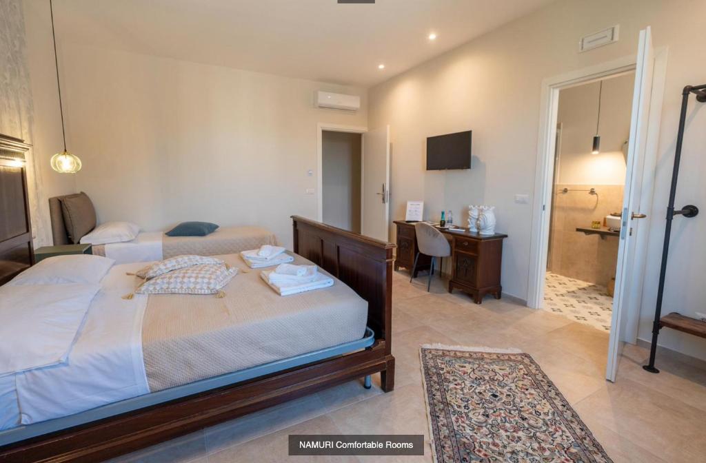 Postel nebo postele na pokoji v ubytování Namuri Comfortable Rooms