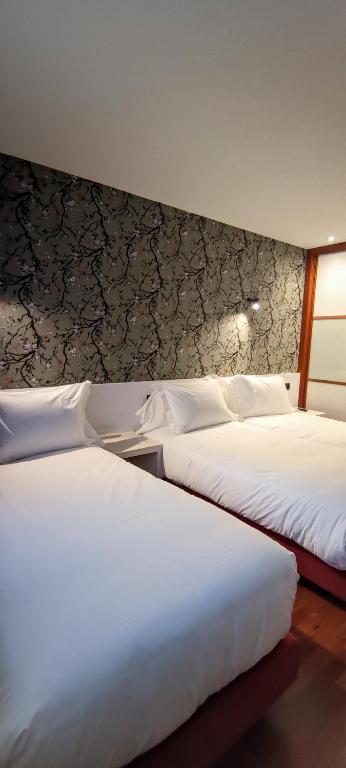 Postel nebo postele na pokoji v ubytování Hotel Apartamentos San Fermín Pamplona