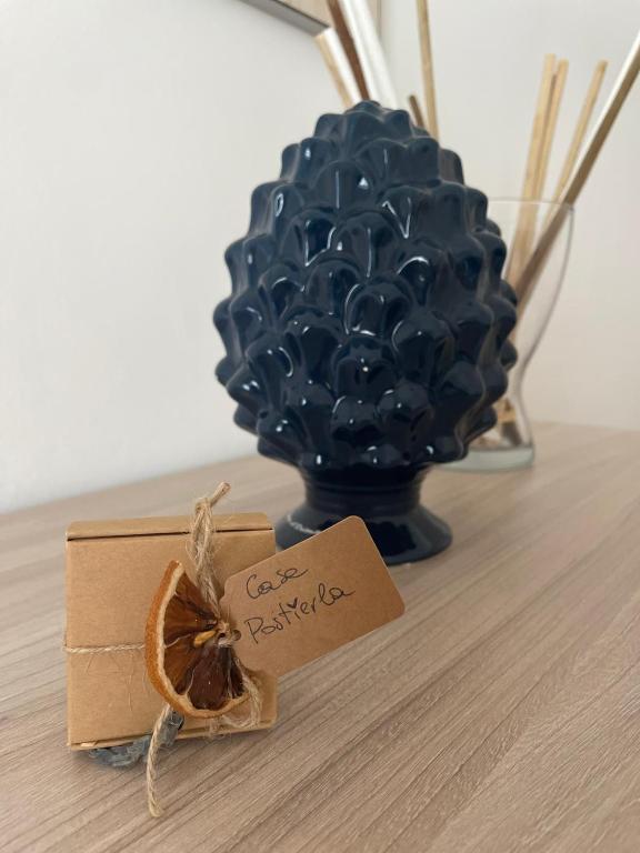 a vase filled with blue balls and a piece of an orange at Casa Postierla SEA VIEW in Cefalù