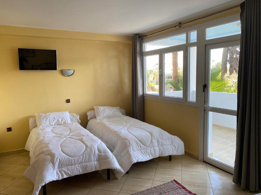 Postel nebo postele na pokoji v ubytování Hôtel Petite Suède