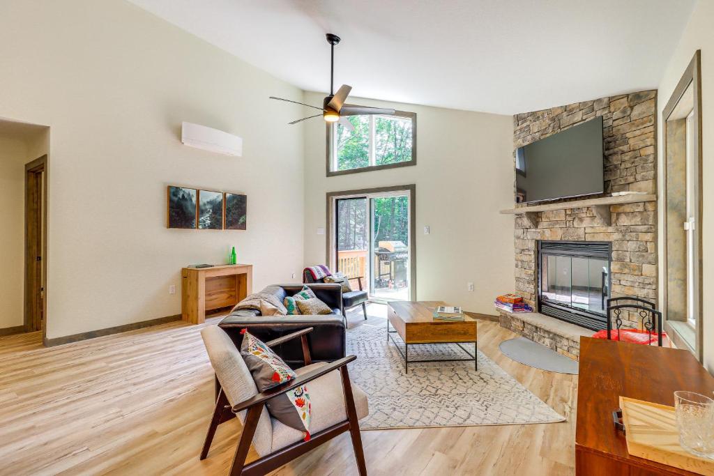 a living room with a couch and a fireplace at Pool and Beach Access Charming Poconos Cabin! in Albrightsville