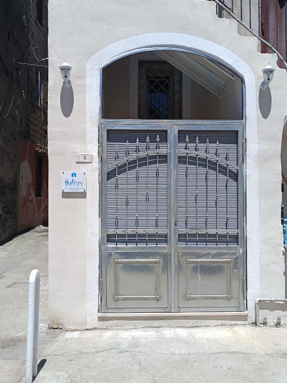 a garage door with a metal gate on a building at Historic House in Ercolano