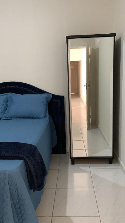 a bedroom with a mirror next to a bed at Desativado in Petrolina
