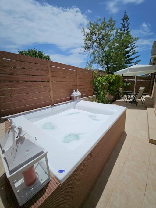 a large bath tub sitting on top of a patio at Villa Stemal in Acharavi