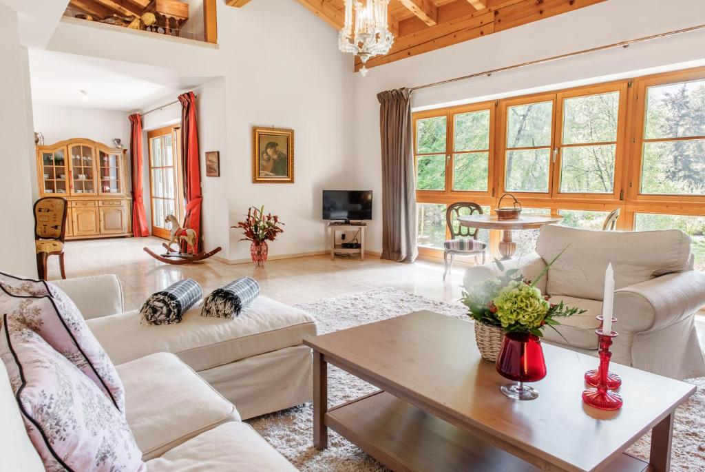 a living room with two couches and a table at The Alpine Apartment in Garmisch-Partenkirchen